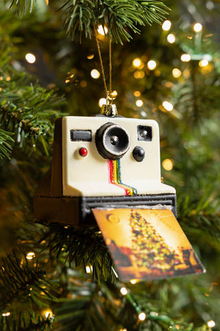 The Polaroid-Inspired Camera Christmas Tree Decoration displayed on a Christmas tree with fairy lights.