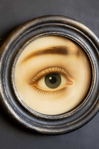Close-up of the Vintage-Style Pretty Eye Framed Wall Art on a black wall.