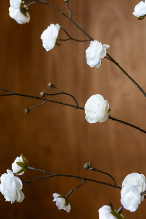 Lifestyle image of the Pretty Faux Ranunculous Stem in White