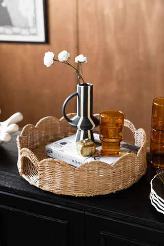 Lifestyle image of the Pretty Round Rattan Scalloped Tray