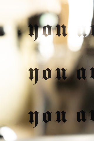A close up of the text details on the Pure Fucking Magic Decorative Mirror. 