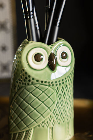 Close-up of the face of the Quirky Green Owl Bud Vase.