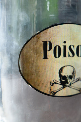 Close-up of the label on the Quirky 'Poison' Glass Decanter.