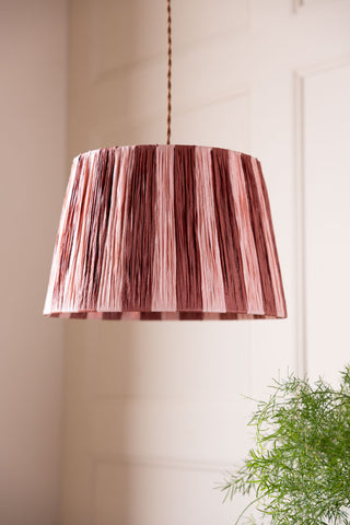Image of the Raffia Pink & Red Stripe Lampshade hanging from the ceiling