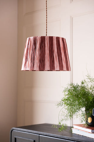 Image of the Raffia Pink & Red Stripe Lampshade hanging from the ceiling