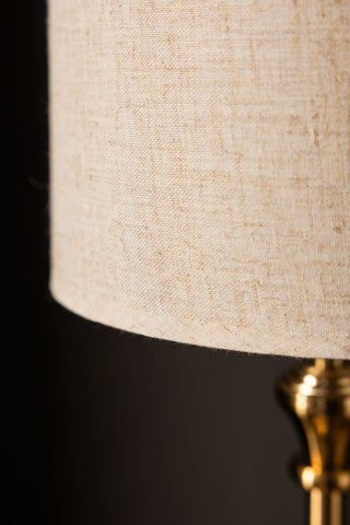 Close-up of a beige lampshade with a dark background
