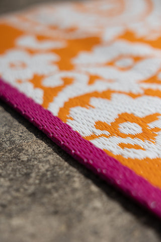 Close-up shot of the Recycled Vintage Design Outdoor Rug in Orange.