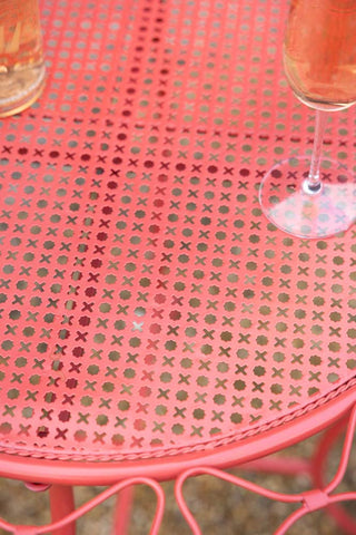 Close-up of the surface of the Red Bow Folding Garden Table & Chairs Set.