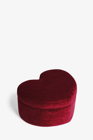 The Red Velvet Heart Footstool With Storage on a white background, seen from an angle.