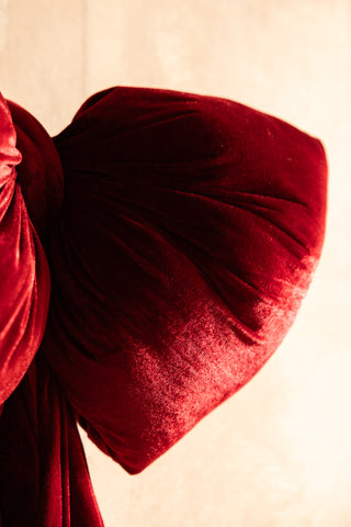Close-up of the Red Velvet Oversized Bow Decoration in front of a white background.