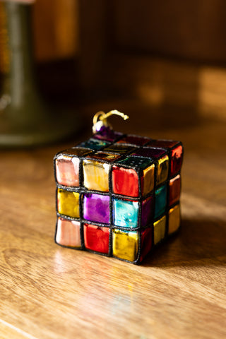 The Retro Colourful Cube Christmas Tree Decoration displayed on a wooden surface.
