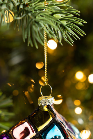 Close-up of the hanging loop of the Retro Colourful Cube Christmas Tree Decoration styled hanging from a tree branch.