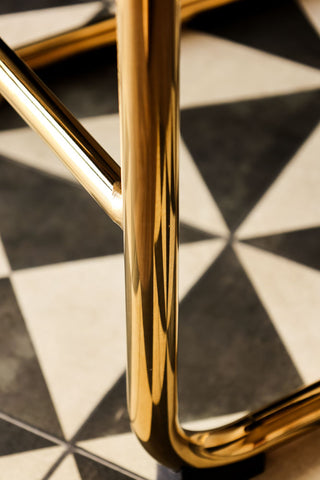 Shiny gold legs of the retro curve back bar stool.