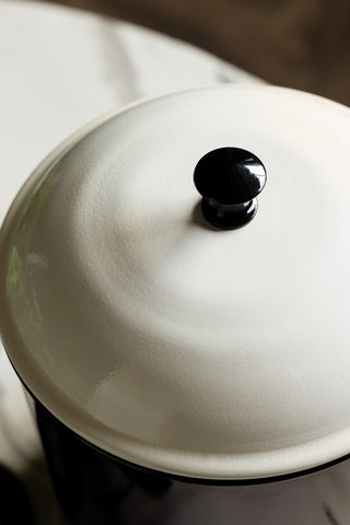 The lid of the Retro Monochrome Enamel Bread Bin, showing the white lid and black handle. 