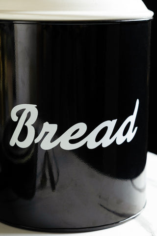 The retro-style "bread" text written across the side of the Retro Monochrome Enamel Bread Bin. 