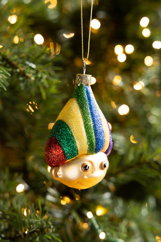 The Retro Troll-Inspired Christmas Tree Decoration hanging from a Christmas tree with some fairy lights.