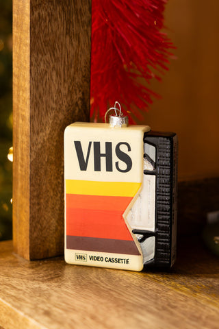 The Retro Video Tape Christmas Tree Decoration styled on a wooden surface.