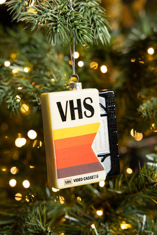 The Retro Video Tape Christmas Tree Decoration styled on a Christmas tree with some fairy lights.