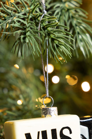 Close-up of the Retro Video Tape Christmas Tree Decoration hanging from a Christmas tree branch.