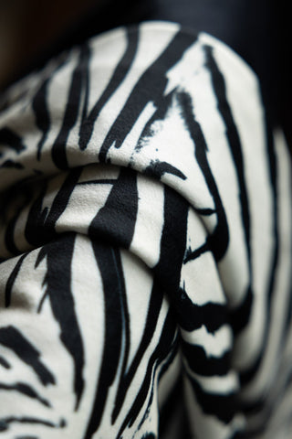 Close-up of the fabric of the Zebra Print Velvet Throw with Tassels.