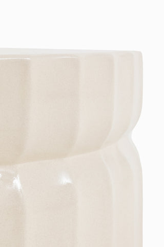 Side view of the top of the Ribbed Edge Round Coffee Table In Ivory on a white background.