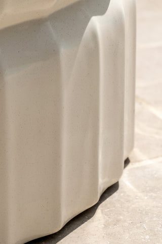Close-up of the side of the Ribbed Edge Round Coffee Table In Ivory.