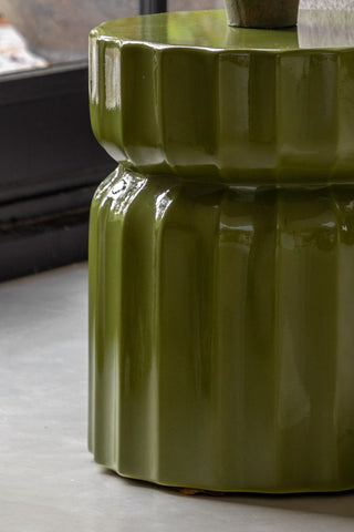 Close-up of the side of the Ribbed Edge Round Side Table in Green Glaze.