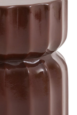 Close-up of the side of the Ribbed Edge Round Side Table in Rust Glaze on a white background.