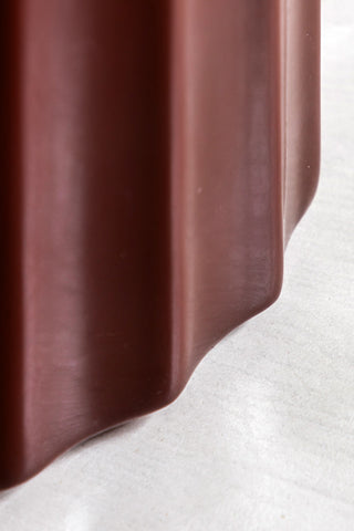 Close-up of the base of the Ribbed Edge Round Side Table in Rust Glaze.