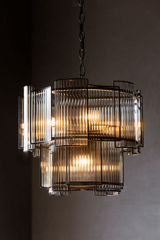 Image of Ribbed Glass Loft Chandelier against a dark wall. 