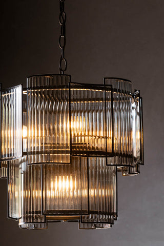 The Ribbed Glass Loft Chandelier shown with the lights on. 