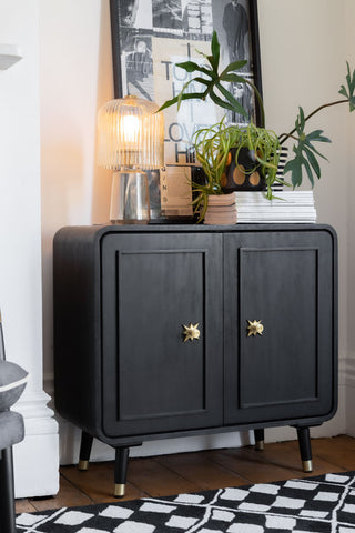 The Black & Gold Ringo Small Sideboard styled with various accessories on.