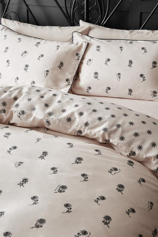 The Rock & Rose Duvet Cover and Pillow Case Set styled on a black framed bed.
