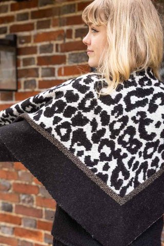 A close-up of a leopard print scarf on a beautiful blonde model