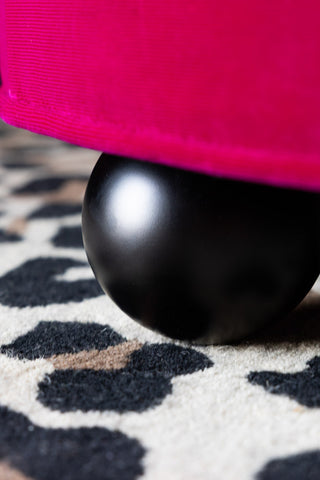 Close-up of one of the feet on the Round Footstool in Harry's Hot Pink Velvet.