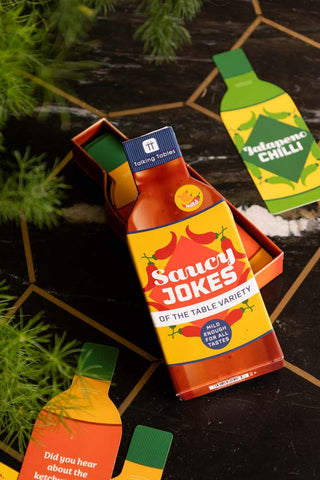 Image of the Saucy Jokes Party Game on a table