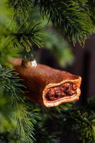 Close-up image of the Sausage Roll Glass Christmas Tree Decoration