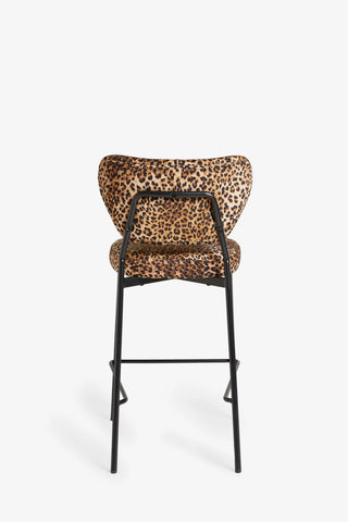 The Leopard Print Velvet Bar Stool seen from the back, on a white background.
