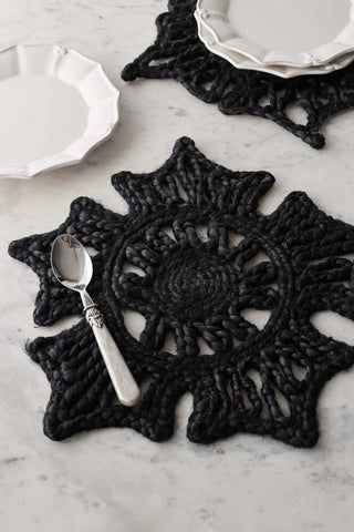 Lifestyle image of the Set Of 2 Black Jute Crochet Flower Placemats