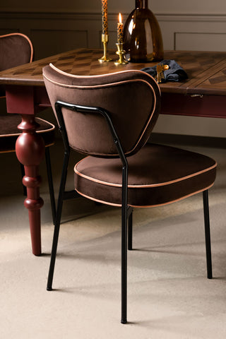 The reverse side of one of the Set Of 2 Dining Chairs in Chocolate Velvet, styled with a dining table.