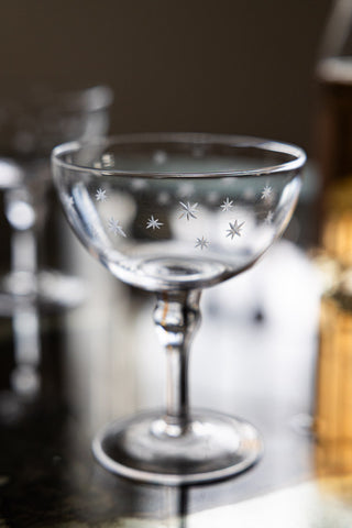 Close-up image of the Set Of 2 Etched Star Champagne Glasses