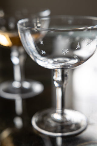 Lifestyle image of the Set Of 2 Etched Star Champagne Glasses