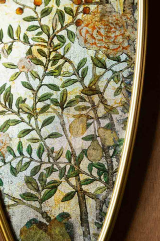 Close-up detail of the fruit tree and flower pattern on the Set of 2 Framed Oval Chinoiserie Wall Hangings. 