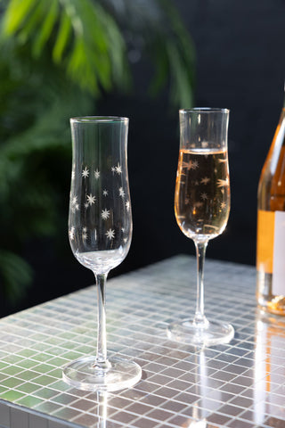 Lifestyle image of the Set Of 2 Etched Star Champagne Flutes