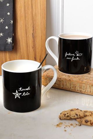 Lifestyle image of the Set Of 2 Sweary Christmas Mugs
