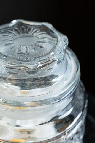 Close-up of the lid of one of the Set Of 2 Vintage-Style Glass Storage Jars.