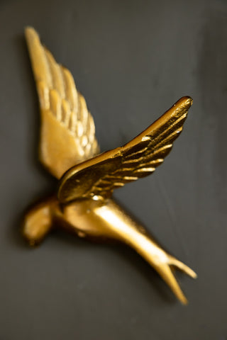 Close-up image of the Set Of 3 Gold Metal Birds Wall Ornament