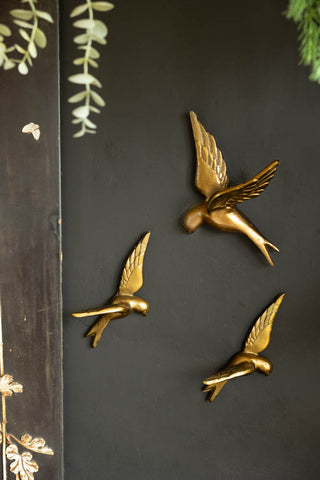 Lifestyle image of the Set Of 3 Gold Metal Birds Wall Ornament