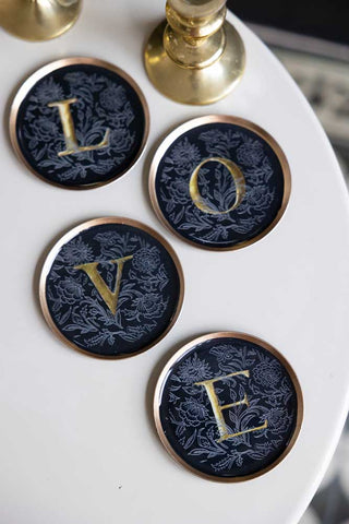 Lifestyle image of the Set Of 4 Black & Gold Love Coasters