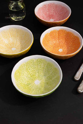 Lifestyle image of the Set Of 4 Grapefruit Bowls on a dark background
